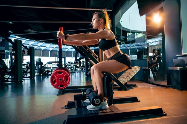 Foto gratuita la atleta femenina entrenando duro en el gimnasio fitness y concepto de vida saludable