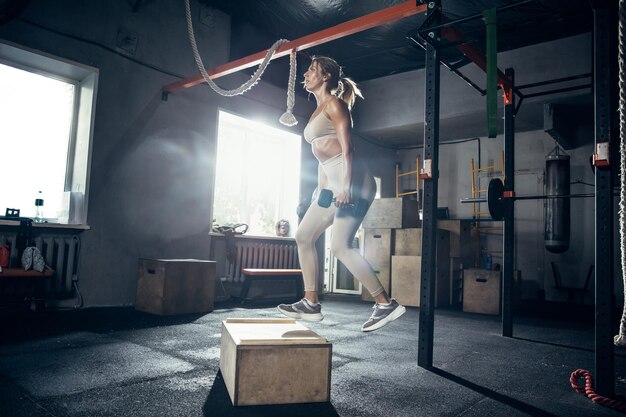 La atleta femenina entrenando duro en el gimnasio.