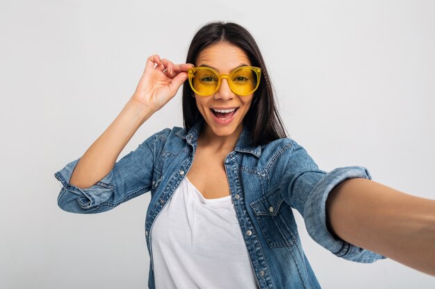 Atractiva mujer feliz sonriente haciendo selfie foto aislado en blanco studio