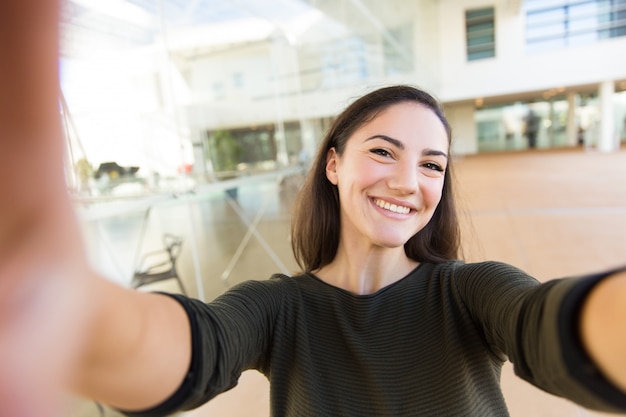 Autorretrato de mujer hermosa alegre con smartphone