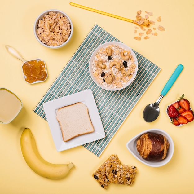 Avena en un bol con tostadas y frutas en la mesa