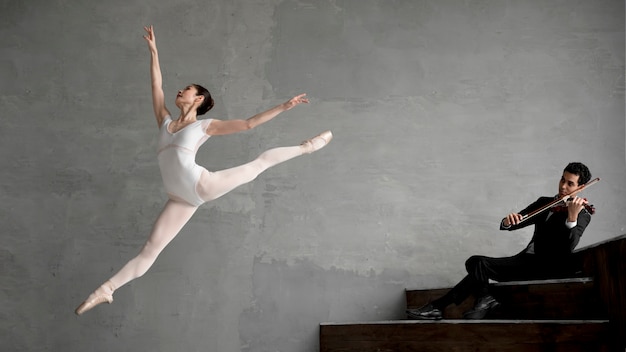 Foto gratuita bailarina bailando al son de la violinista