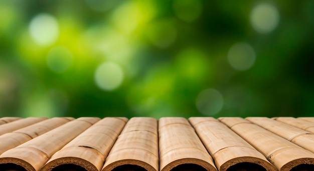 Bamboo table with green bokeh background