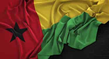 Foto gratuita bandera de guinea-bissau arrugado sobre fondo oscuro 3d render