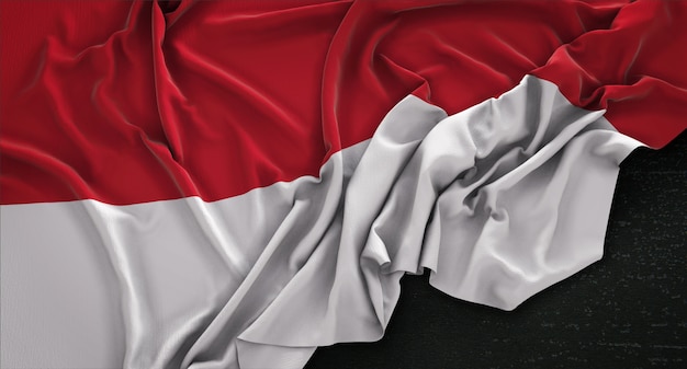 Bandera de Indonesia arrugado sobre fondo oscuro 3D Render