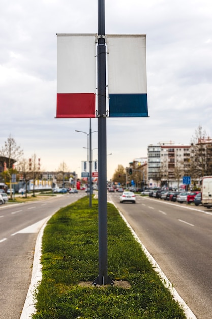 Foto gratuita la bandera publicitaria en blanco de doble cara cuelga del poste de la farola.