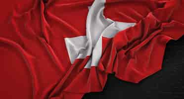 Foto gratuita bandera de suiza arrugado sobre fondo oscuro 3d render