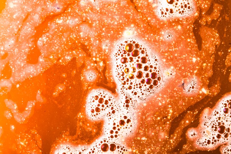 Foto gratuito un baño de naranja bombea agua con burbujas.