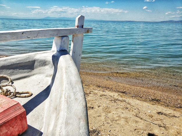 Foto gratuita barco estacionado en la costa arenosa del mar