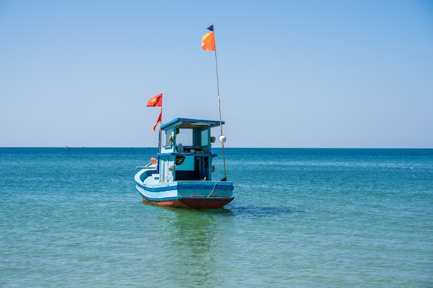 Barco de pescadores de madera con una bandera vietnamita