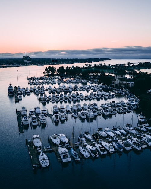 barcos blancos en un río rodeado de vegetación y pueblos durante el atardecer