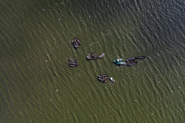 Barcos de pesca, flotando en las tranquilas aguas y yendo a pescar