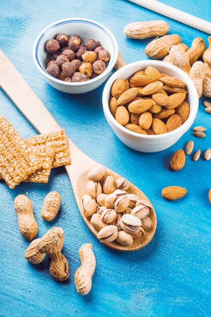 Barra de proteínas hecha con frutos secos sobre fondo de textura azul