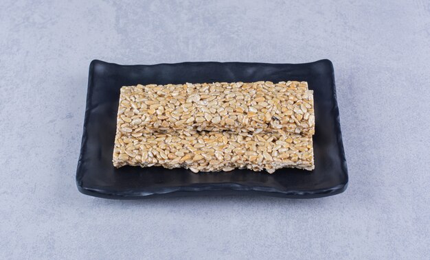 Barras de granola en un plato sobre la superficie de mármol