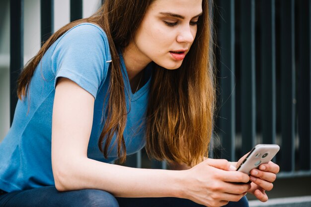 Bastante adolescente con teléfono inteligente