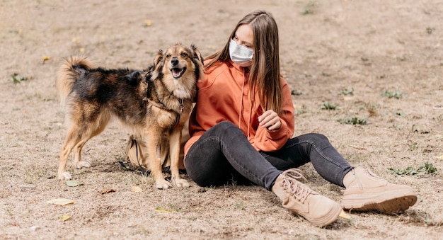 Bastante joven acariciando a su perro