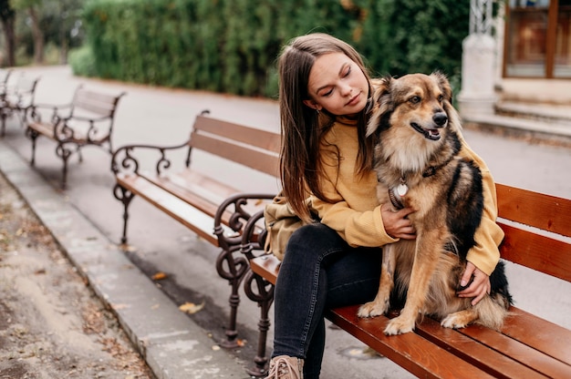 Bastante joven acariciando a su perro