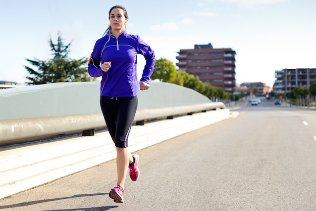 Foto gratuita bastante joven corriendo en la ciudad.