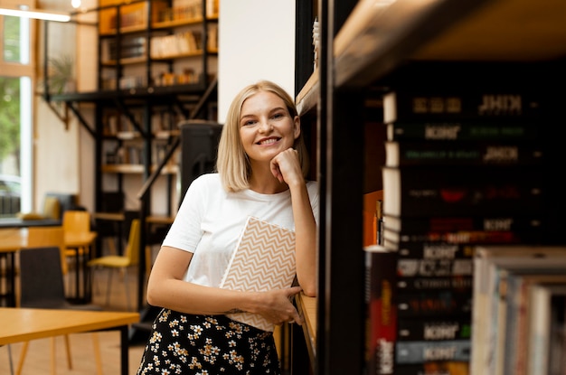 Foto gratuita bastante joven posando en la biblioteca