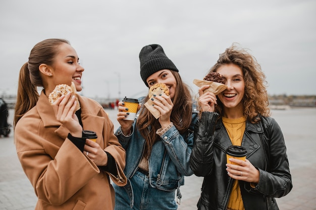 Bastante jóvenes disfrutando de dulces juntos