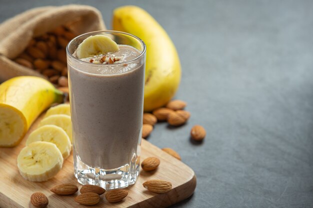 Batido de plátano y almendra sobre fondo oscuro