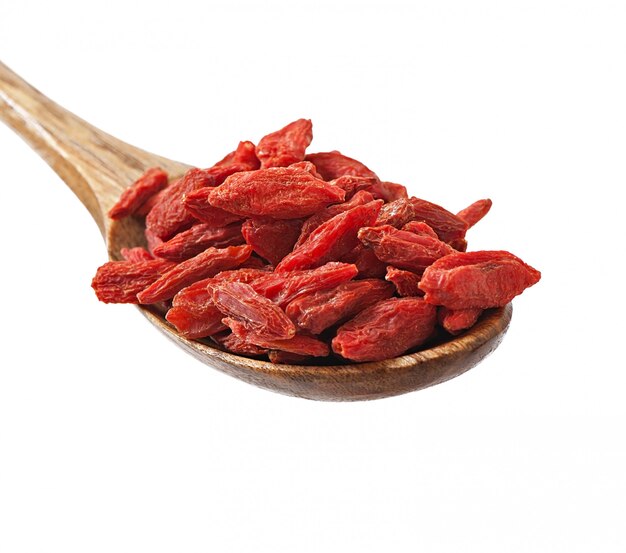 Bayas de goji secas rojas en cuchara de madera