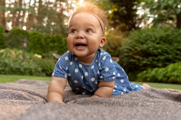 Bebé sonriente de tiro completo en la naturaleza