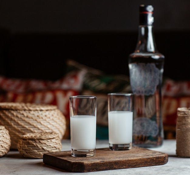 Bebida de alcohol turco raki, vodka, en dos vasos pequeños.