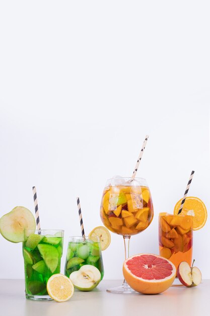 Bebidas con manzana, pomelo y paja en blanco