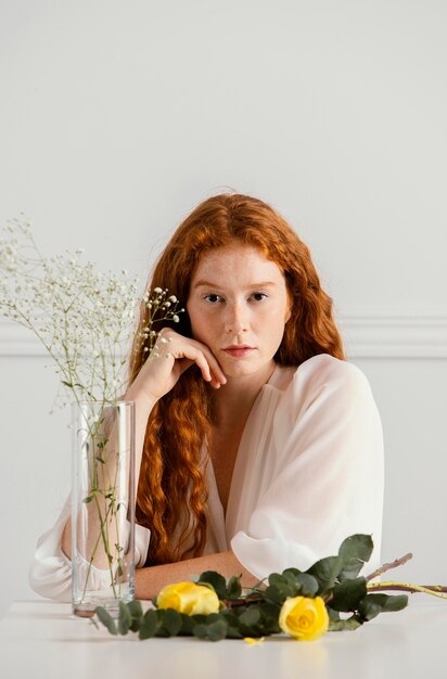 Bella mujer posando con flores de primavera