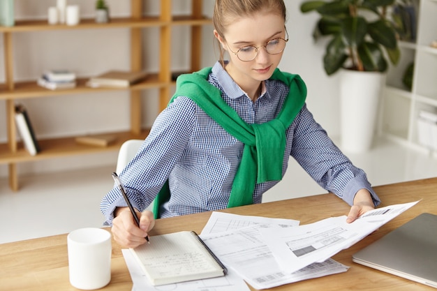 Bella mujer vestida formalmente en escritura de oficina