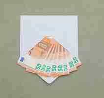 Foto gratuita billetes de euro en sobres en la mesa de color gris verdoso.