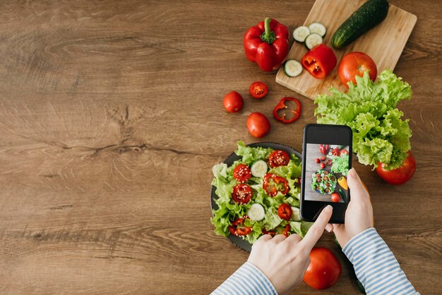 Blogger de comida femenina streaming con smartphone en casa