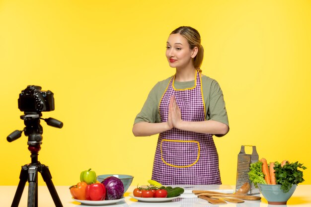 Blogger de comida lindo chef saludable grabando video para redes sociales rezando y sonriendo