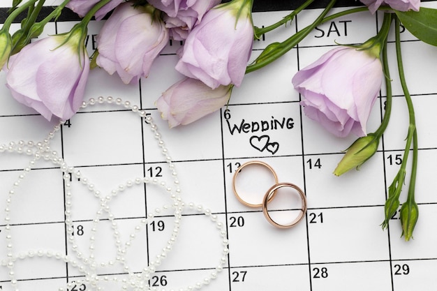 Boda con dos corazones escritos en calendario y anillos