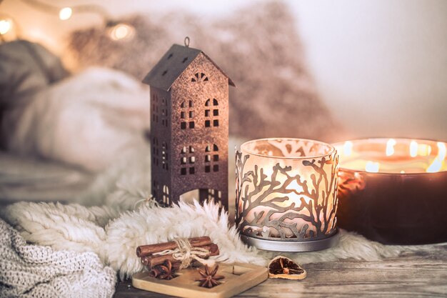 Bodegón en el interior con hermosas velas, sobre la mesa de una acogedora decoración del hogar