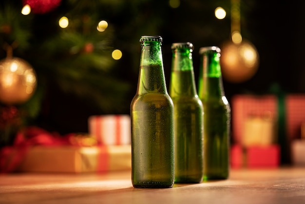 Foto gratuita bodegón surtido de botellas de cerveza navideñas