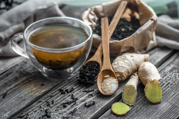 Foto gratuita bodegón con transparente taza de té sobre fondo de madera