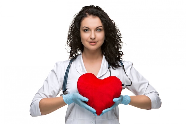 Bonita doctora sosteniendo un corazón rojo