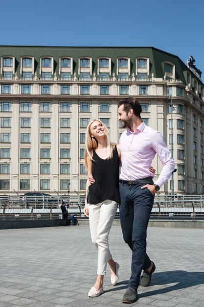 Bonita pareja de hombre alegre y una mujer caminando en la calle