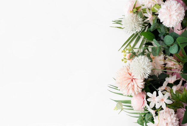 Borde de flor rosa con hojas de palmera sobre fondo blanco.