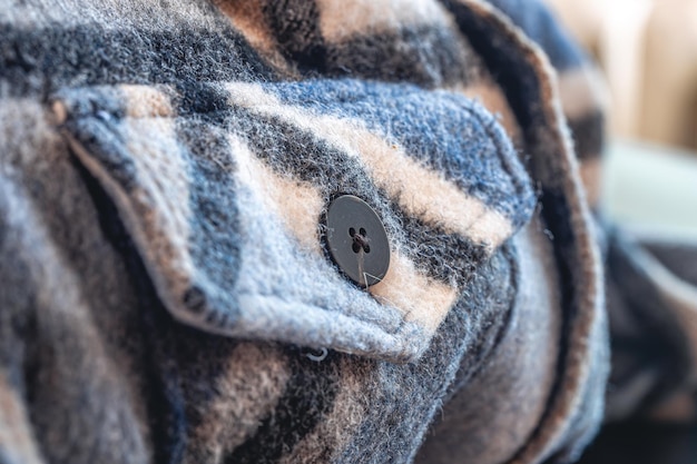 Botón en una cálida foto macro de camisa azul