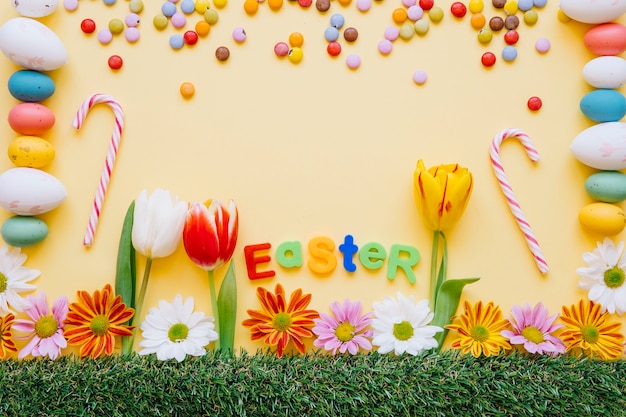 Brillantes dulces y flores para vacaciones de Pascua