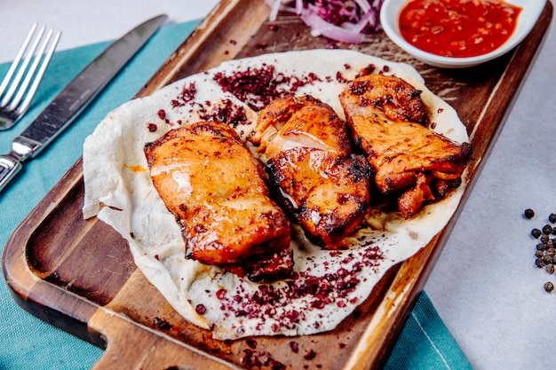 Brocheta de pollo en una tabla de madera