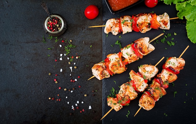 Foto gratuita brochetas de pollo con rodajas de pimientos y eneldo.