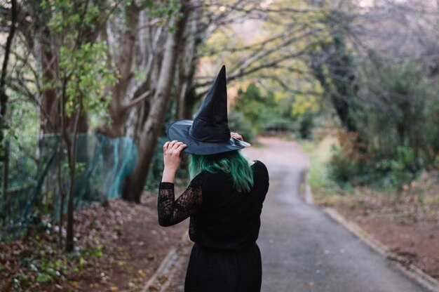 Bruja en sombrero de la explotación forestal del camino