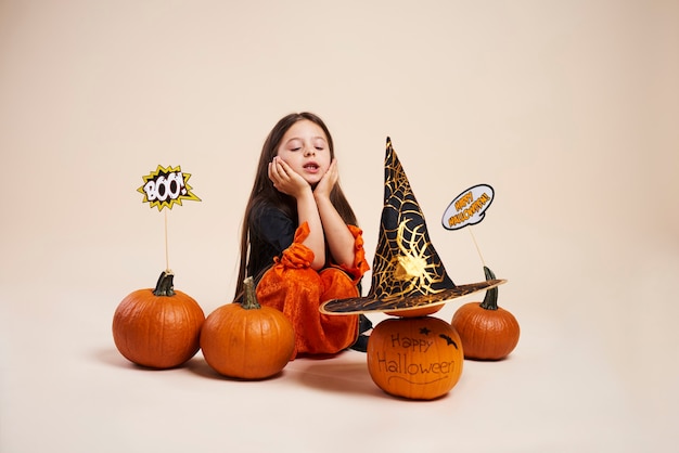 Foto gratuita brujita con calabaza de halloween