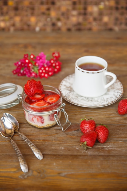 Foto gratuita budín de fresa con sirope de fresa servido con té