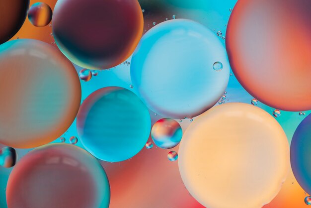 Burbujas multicolores brillantes con gotas.