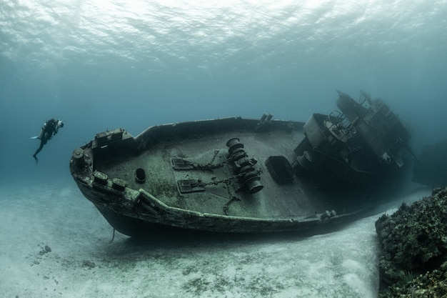 Buzos examinando el famoso submarino USS Kittiwake hundido en las Islas Gran Caimán